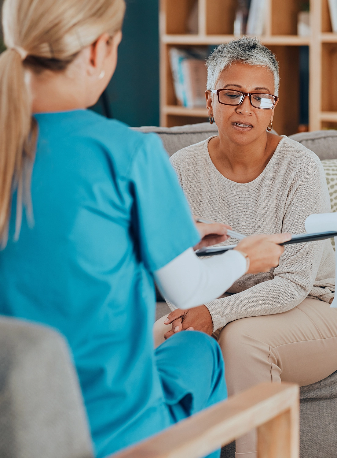 A nurse going over paperwork with a patient